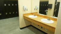 Locker room, dual sinks in foreground, lockers in background