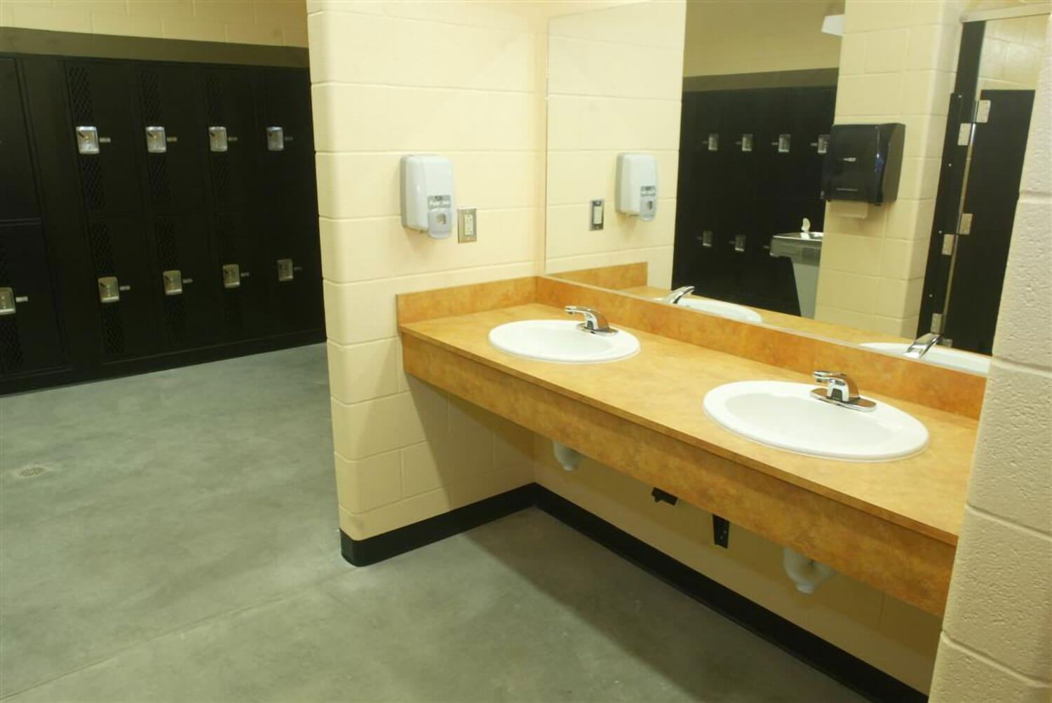 Locker room, dual sinks in foreground, lockers in background