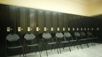 Locker room, folding chairs line up in front of lockers